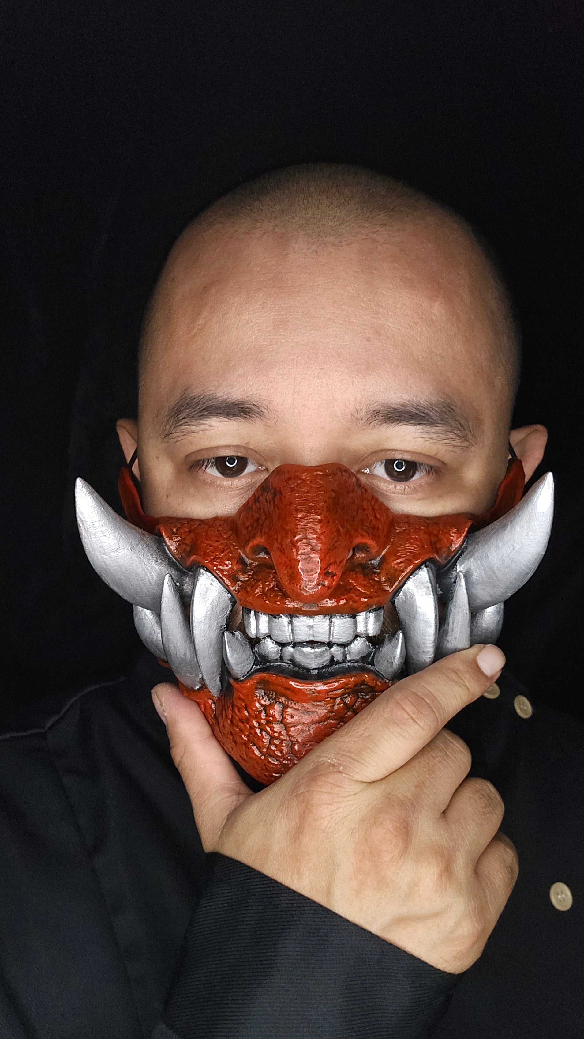 Hand painted Half Oni Mask showing sharp fangs and textured surface